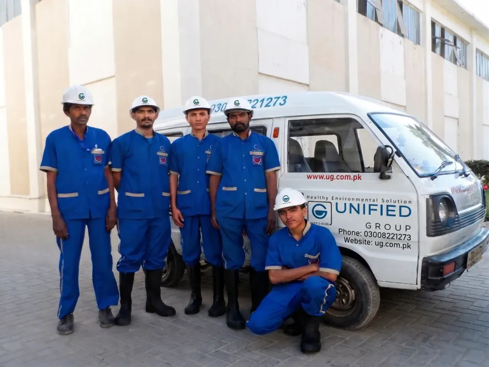 Unified Group technicians with the branded service van in Karachi